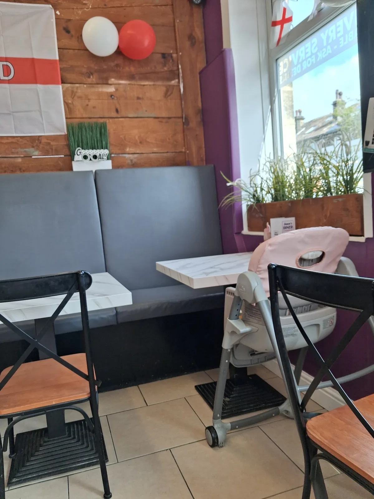 Window seats, wooden walls and tables inside Dawn's Diner