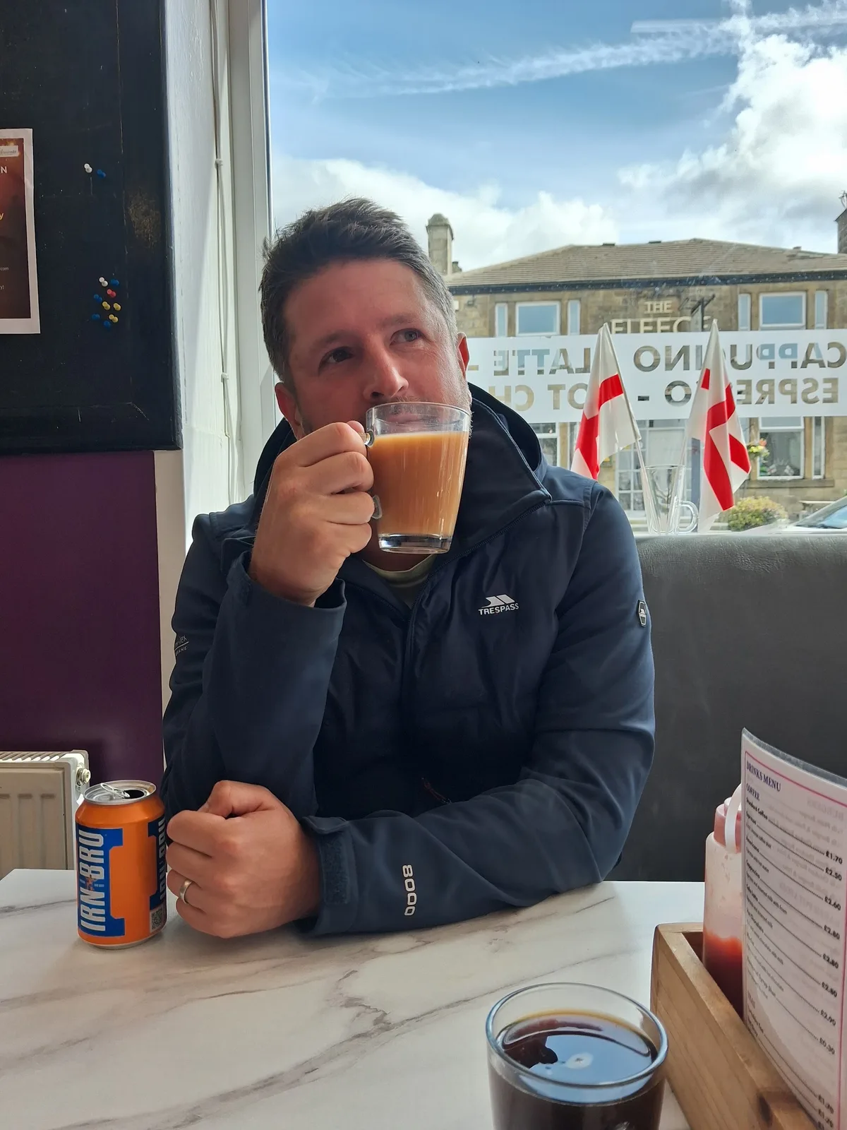 A customer enjoying a cup of tea by the café window
